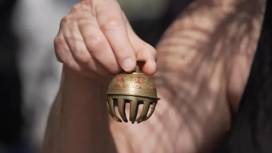 Forest therapy guide Shawn Ramsey rings a tiny brass bell during a “forest bathing” session at the JC Raulston Arboretum in Raleigh, N.C., on Sunday, March 22, 2026. (AP Photo/Allen G. Breed)
